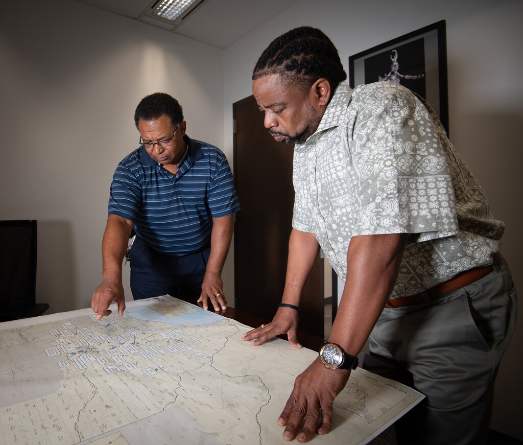Clarence Banks, left, the Fort Worth District’s Value Officer, discusses projects and their location with his assistant, Derrick McCollum, an engineering technician that supports the Value Engineering office, Sept. 11, 2024. Value Engineering is a systematic, organized approach that promotes the substitution of materials and methods with less costly alternatives, without sacrificing functionality of the overall project.