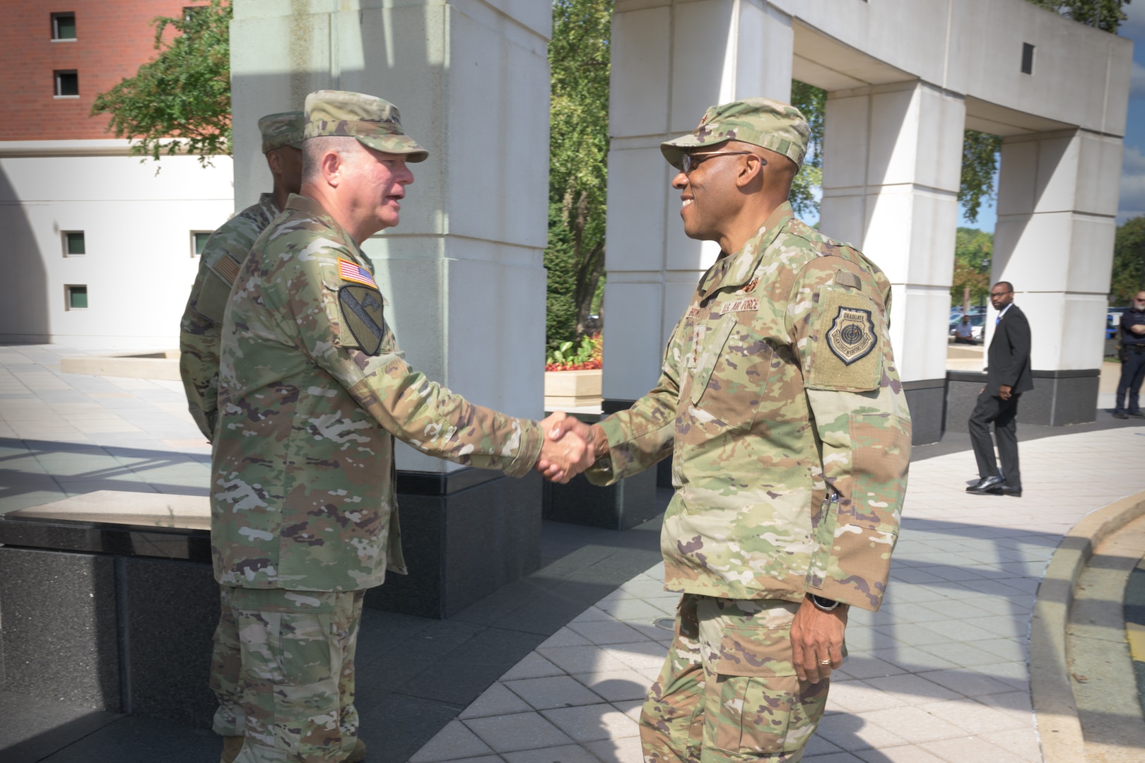 Defense Logistics Agency Director Army Lt. Gen. Army Lt. Gen. Mark Simerly, left, greets Chairman of the Joint Chiefs of Staff Air Force Gen. Charles Q. Brown Jr., right, during the Worldwide Logistics Symposium at the McNamara Headquarters Complex at Fort Belvoir, Virginia