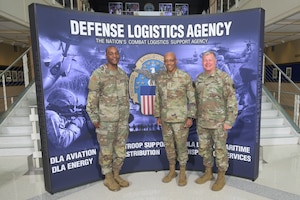 Defense Logistics Agency Director Army Lt. Gen. Army Lt. Gen. Mark Simerly, left, Chairman of the Joint Chiefs of Staff Air Force Gen. Charles Q. Brown Jr., center, and DLA Senior Enlisted Leader Air Force Command Chief Master Sergeant Alvin R. Dyer pose for a photo during the Worldwide Logistics Symposium at the McNamara Headquarters Complex at Fort Belvoir, Virginia