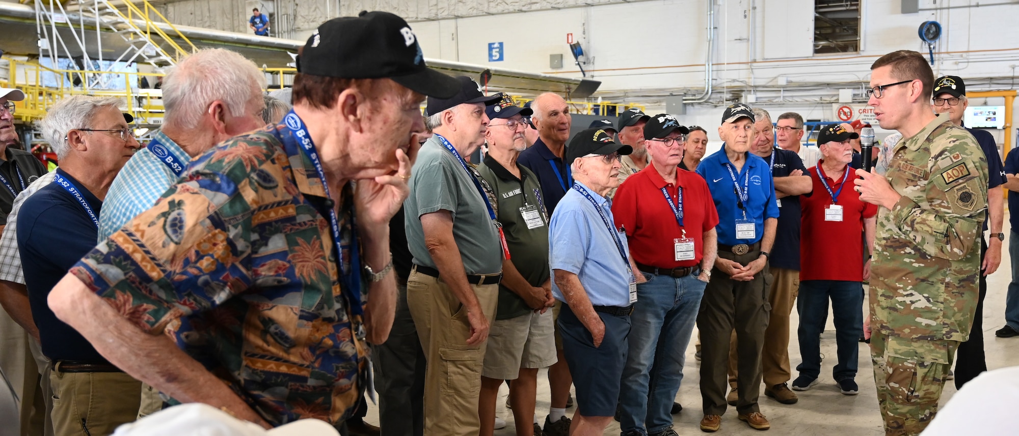 Group of people listening to man.