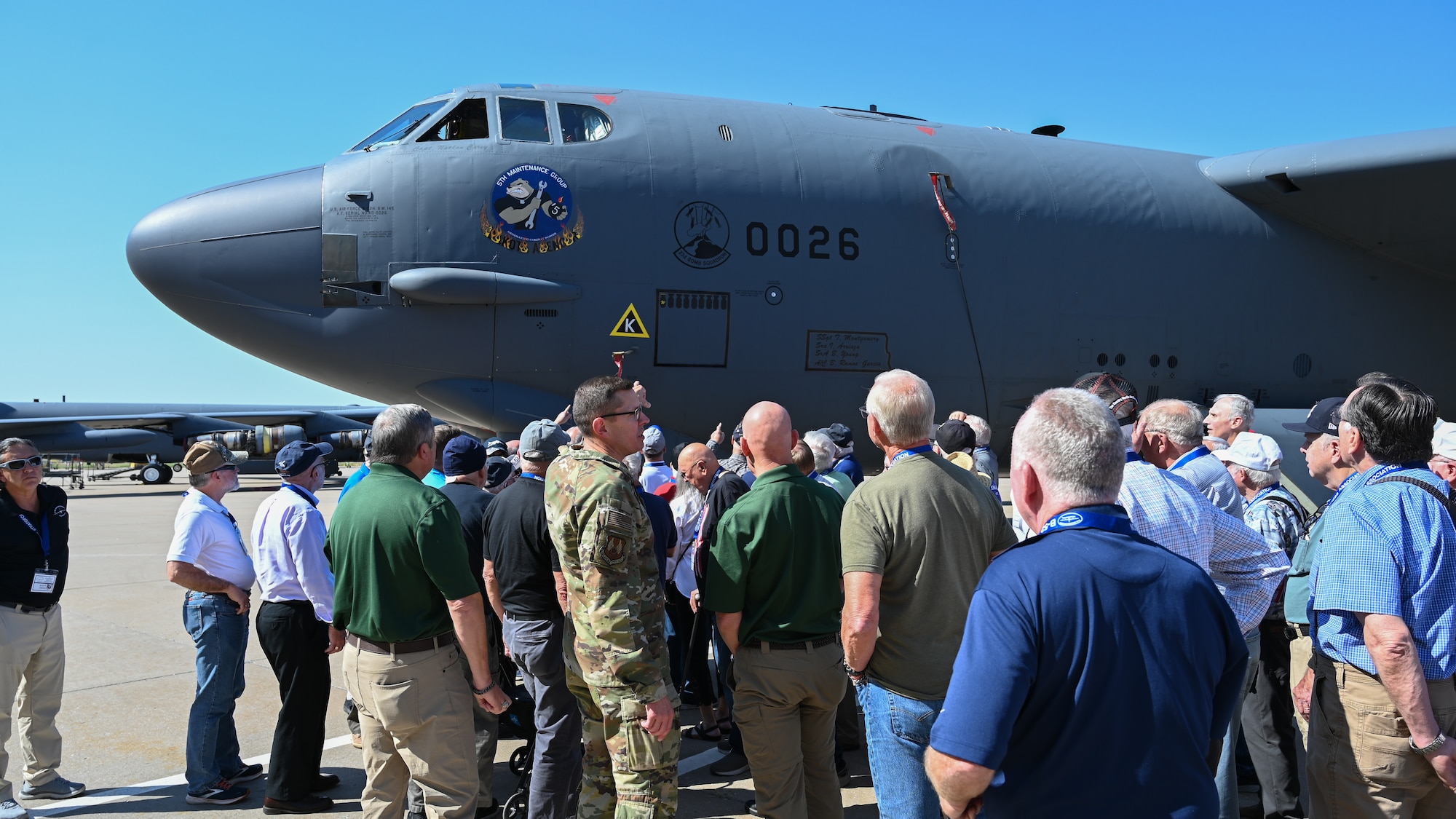 Group of people looking at aircraft.