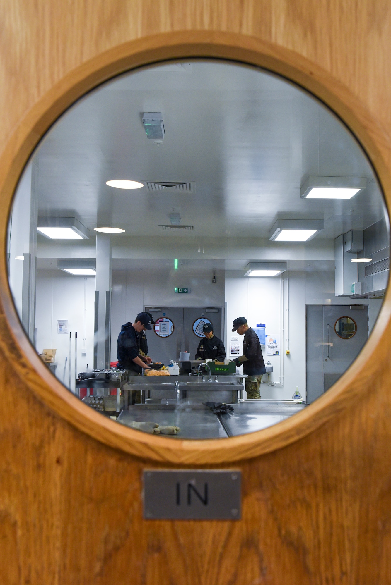 The 100th Air Refueling Wing command team and 100th Force Support Squadron Gateway Dining Facility Airmen cut cantaloupe in preparation for a meal during a “Day in the Life” immersion at Royal Air Force Mildenhall, England, Sept. 13, 2024.