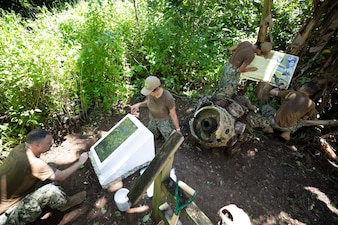 Sailors supporting Pacific Partnership preserve World War II memorial markers at multiple WWII crash sites on the Island of Yap.