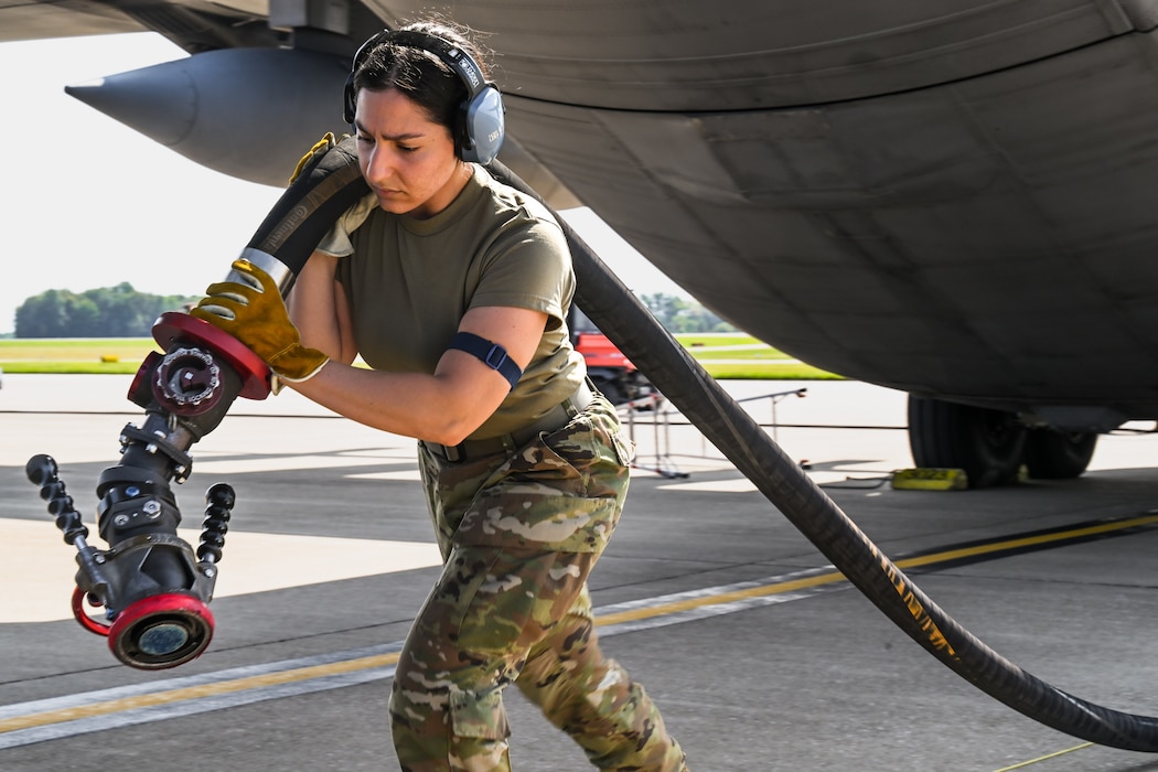 Staff Sgt. Victoria Russo, a fuel systems specialist with the 910th Logistics Readiness Squadron, drags a fuel hose after refueling a C-130H Hercules at Youngstown Air Reserve Station, Ohio, Sept. 12, 2024.