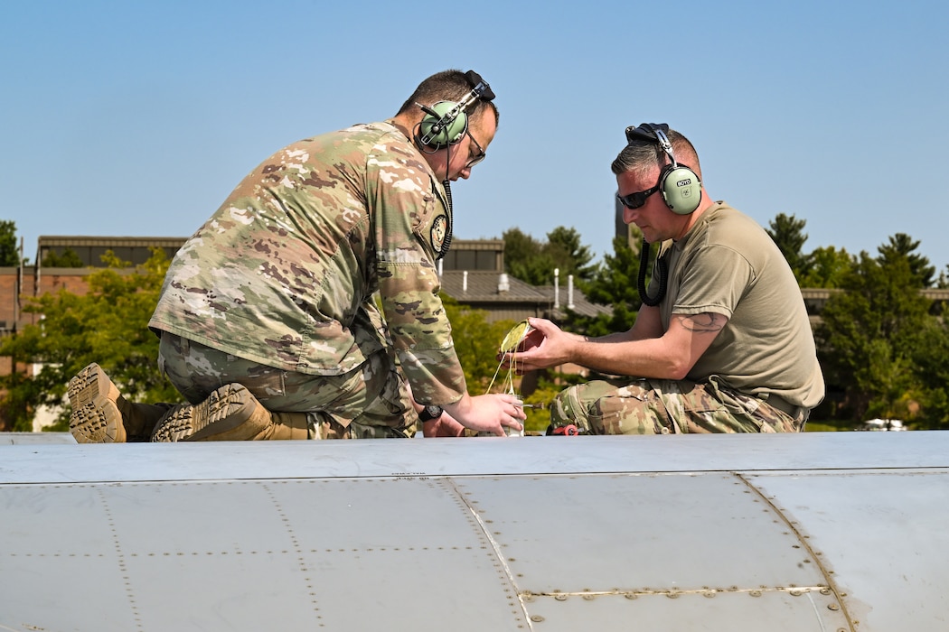 Tech. Sgt. Luke Prox, assistant Dedicated Crew Chief with the 910th Aircraft Maintenance Squadron, and Master Sgt. Levi Boyd, DCC with the 910th AMXS, perform maintenance work on the wing of a C-130H Hercules at Youngstown Air Reserve Station, Ohio, Sept. 12, 2024.