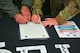 U.S. Air Force Col. Benjamin Jensen, 5th Bomb Wing deputy commander (left), and U.S. Air Force Col. George Chapman, 91st Missile Wing deputy commander (right), sign a proclamation in support of Hispanic Heritage Month during its opening ceremony at Minot Air Force Base, North Dakota, Sept. 16, 2024. Celebrated from September 15 to October 15, Hispanic Heritage Month is the only Department of Defense special observance to span multiple months, coinciding with Independence Day celebrations for multiple Latin American countries.