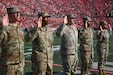 Soldier of the 1st Theater Sustainment Command raise their right hands and recite the Oath of Enlistment at the mass reenlistment ceremony, Sept. 7,2024, University of Louisville, Kentucky. These Soldiers from the 1st TSC chose to continue their military careers and serve their country.