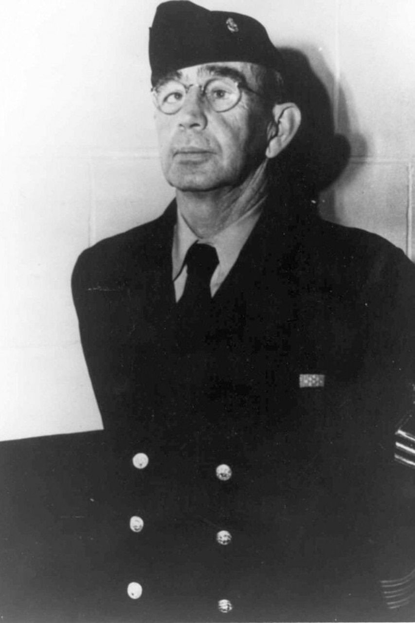 A person in uniform stands at attention.