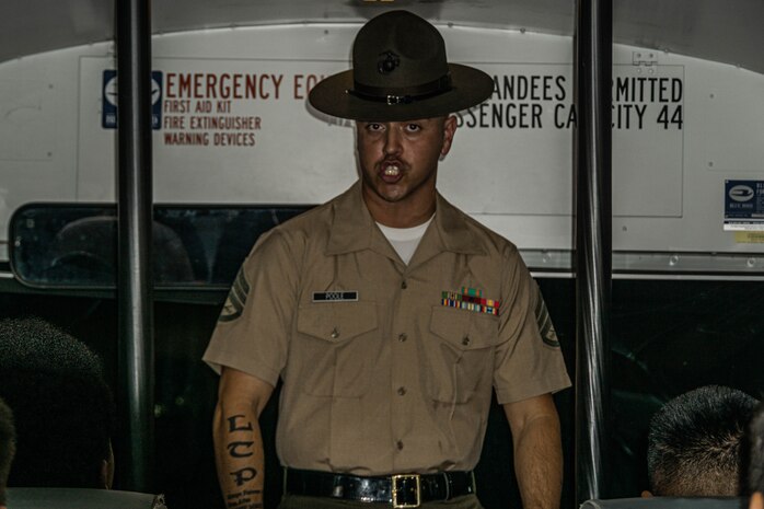 U.S. Marine Corps Staff Sgt. Asen Poole, a drill instructor with Receiving Company, Support Training Battalion, instructs recruits for their first time on the bus as part of the receiving process at Marine Corps Recruit Depot San Diego, California, September 9, 2024. During the receiving process, recruits are checked for contraband, given haircuts, make scripted phone calls home, and issued the gear necessary for recruit training. (U.S. Marine Corps photo by Cpl. Alexandra M. Earl)