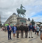 Maj. Gen. John Rueger, the 35th Infantry Division commander, Command Sgt. Maj. Rob Istas, and Aide-de Camp Maj. Dustin Dice, along with several Orleans city officials, pose with a statue of Joan of Arc in Orleans, France, Aug. 16, 2024. The command team visited Orleans Aug. 14-18 in honor of the 80th anniversary of the liberation of Orleans, a battle in which the 35th Infantry Division was instrumental.