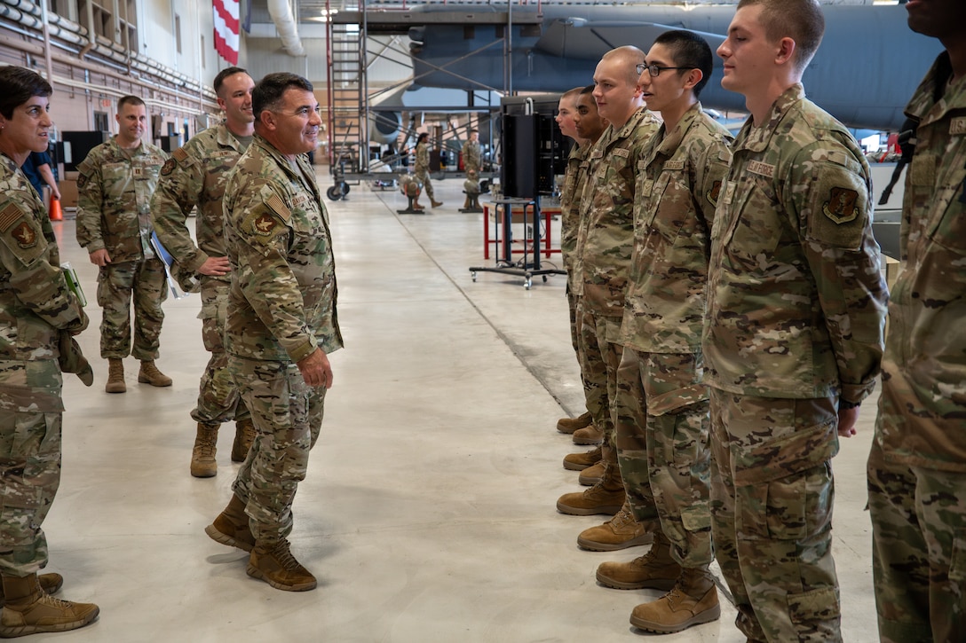 An Airman addresses more Airmen, who are standing at attention.