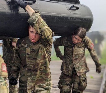 New York Army Guard 1st Lt. Rebeka Eaton shoulders and inflatable boat during the Sappers Leader Course at Fort Leonard Wood, Missouri, in June 2024. Eaton earned her Sapper Tab on June 14. She is one of four New York National Guard Soldiers who can wear the coveted award and the first New York National Guard woman to do so.