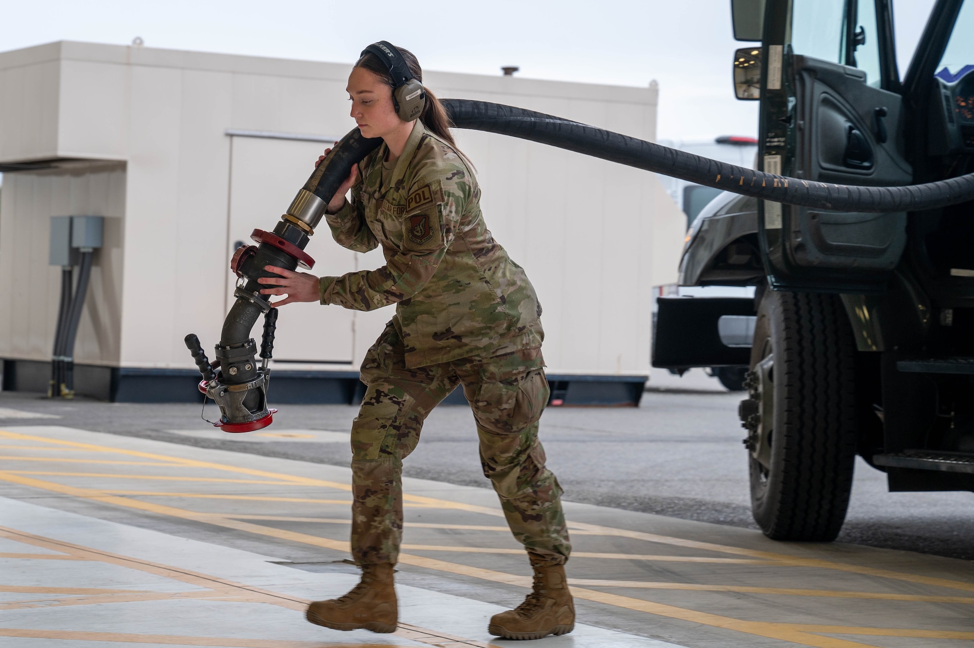 U.S. Air Force Airman Kaelin Sanders, 354th Logistics Readiness Squadron fuels operator, pulls a fueling hose out of an R11 aircraft refueling vehicle before refueling an F-35A Lightning II at Eielson Air Force Base, Alaska, Sept. 12, 2024.