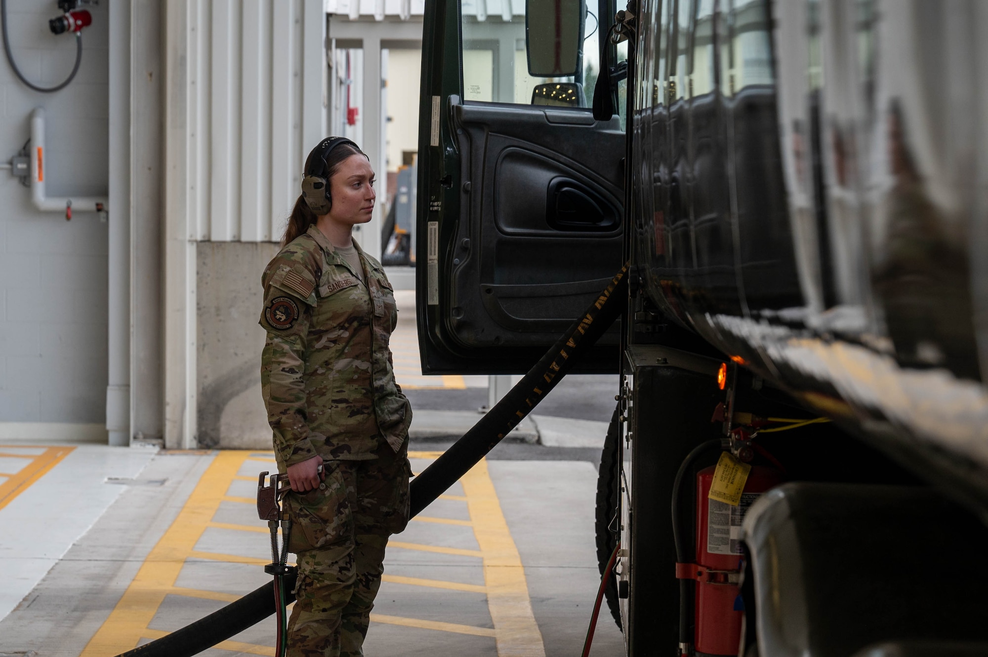 U.S. Air Force Airman Kaelin Sanders, 354th Logistics Readiness Squadron fuels operator, stands by an R11 aircraft refueling vehicle while it refuels an aircraft at Eielson Air Force Base, Alaska, Sept. 12, 2024.