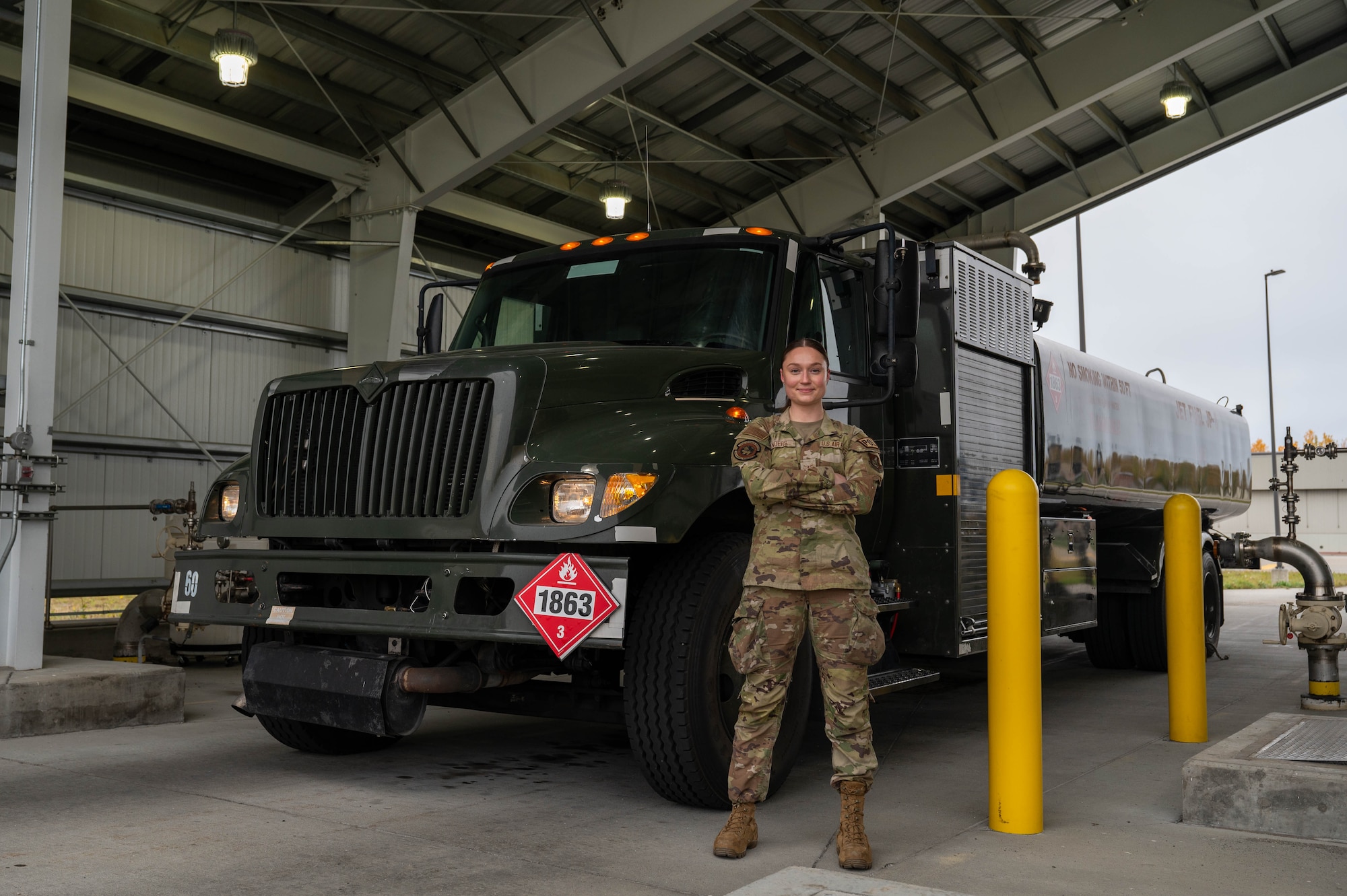 U.S. Air Force Airman Kaelin Sanders, 354th Logistics Readiness Squadron fuels operator, poses for a photo in front of an R11 aircraft refueling vehicle at Eielson Air Force Base, Alaska, Sept. 12, 2024.