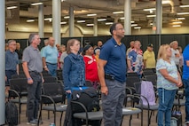 Photo of of attendees standing at the ceremony