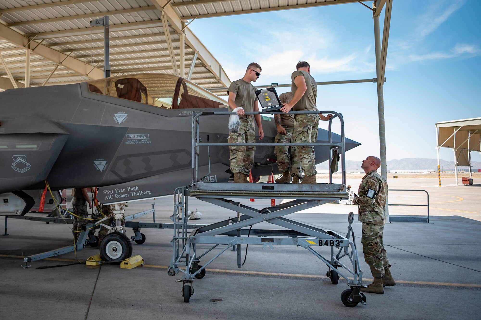 Reserve Citizen Airmen from the 944th Maintenance Group perform maintenance on an F-35 fighter jet while referencing technical data at Luke Air Force Base, Ariz., Sept. 8, 2024. They are responsible for keeping the jets in top shape despite extreme weather conditions. (U.S. Air Force photo by Tech. Sgt. Tyler J. Bolken)