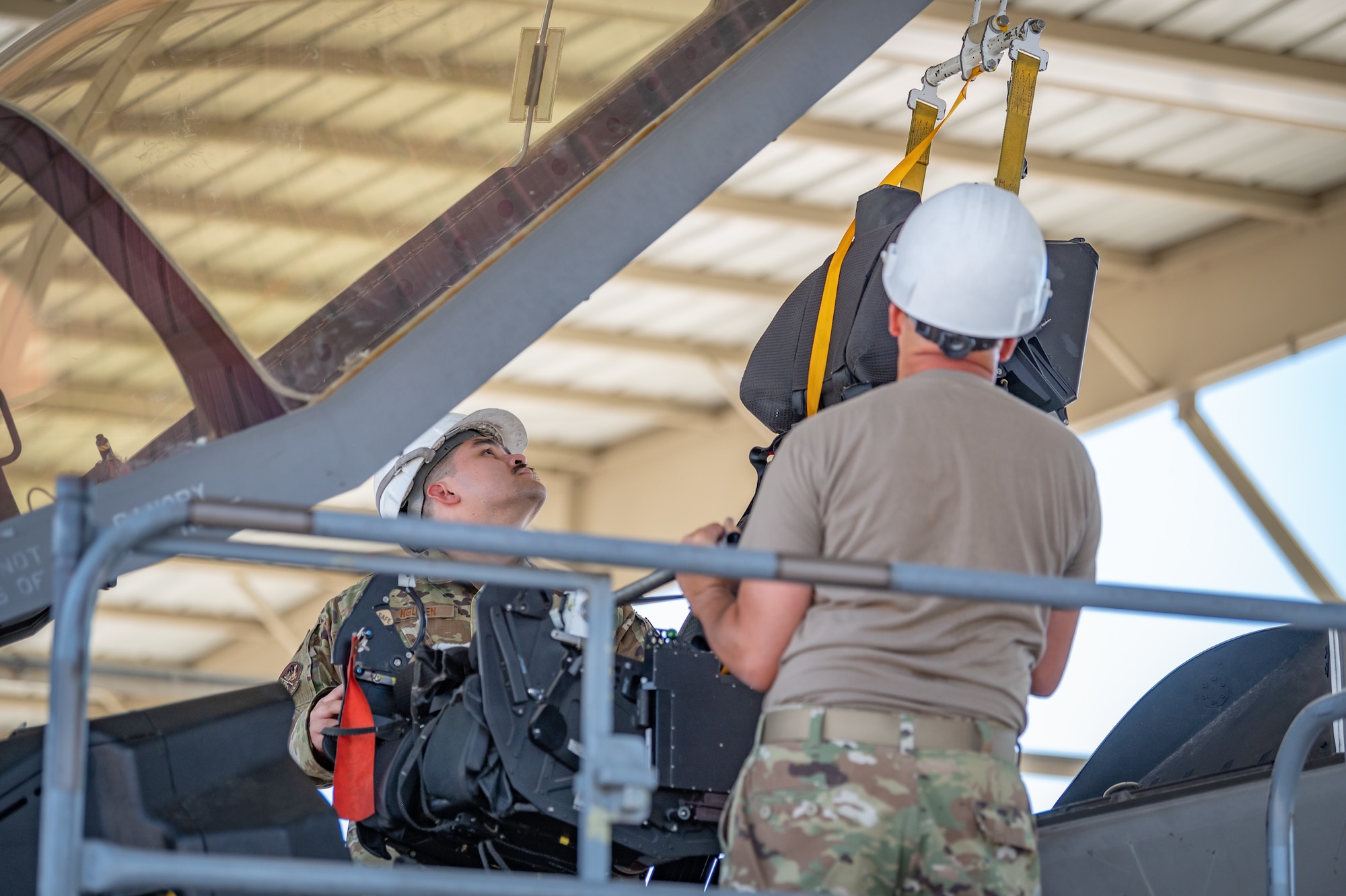 Two Reserve Citizen Airmen carefully lift a component during maintenance on an F-35 at Luke Air Force Base, Ariz., Sept. 8, 2024. Precision is key when working on advanced aircraft systems. (U.S. Air Force photo by Tech. Sgt. Tyler J. Bolken)
