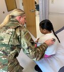 U.S. Air Force Capt. Kaitlyn Brenner, a physician assistant assigned to the 148th Fighter Wing, Minnesota Air National Guard, cares for a patient during an Innovative Readiness Training mission at Fort Belknap Indian Reservation, Montana, Aug. 9, 2024.