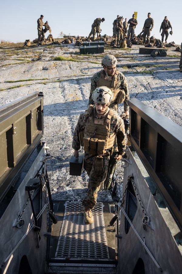 U.S. Marines load ammo cans onto a Swedish CB90 combat boat near Berga Naval Base, Sweden, September 4, 2024. Marines assigned to 4th Assault Amphibian Battalion, 4th Marine Division, Marine Forces Reserve, were deployed for training in support of Exercise Archipelago Endeavor, an annual integrated, Swedish Armed Forces-led exercise that increases operational capabilities between U.S. Marines and Swedish Forces. (U.S. Marine Corps photo by Sgt. Scott Jenkins)