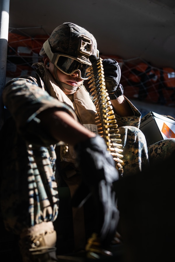 A U.S. Marine assigned to 4th Assault Amphibian Battalion organizes linked 7.62 mm ammunition into an ammo can near Berga Naval Base, Sweden, September 4, 2024. Marines assigned to 4th Assault Amphibian Battalion, 4th Marine Division, Marine Forces Reserve, were deployed for training in support of Exercise Archipelago Endeavor, an annual integrated, Swedish Armed Forces-led exercise that increases operational capabilities between U.S. Marines and Swedish Forces. (U.S. Marine Corps photo by Sgt. Scott Jenkins)