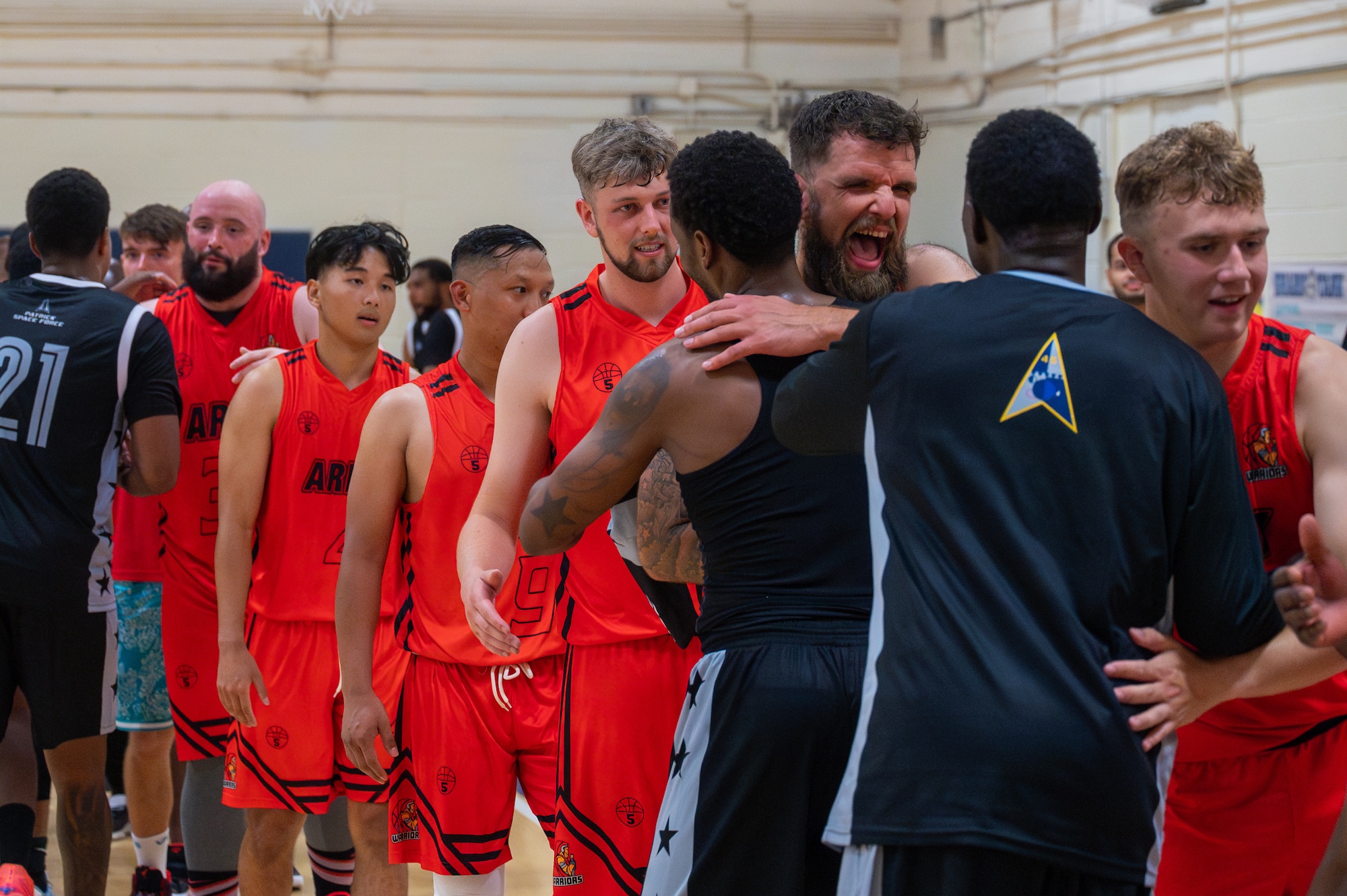 Two teams line up to say 'good game' after a basketball game.