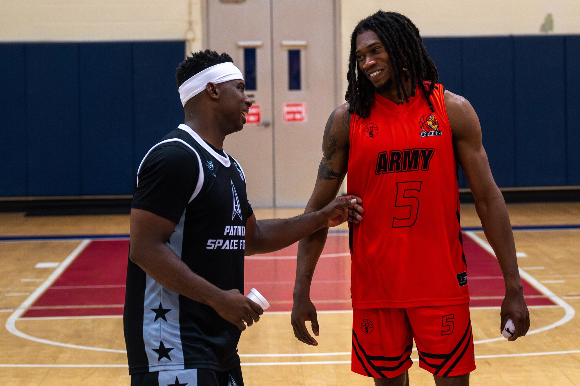 Basketball players talk after a game.