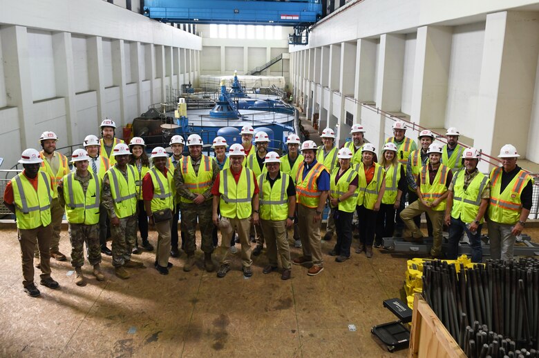 U.S. Army Corps of Engineers Nashville District officials pose for a photo with the U.S. Army Engineer Research and Development Center (ERDC) Board of Directors in front of turbines at the Barkley Dam hydropower facility in Grand Rivers, Ky. during a visit on Sept. 23, 2024. The visit aimed to explore opportunities for innovation and collaboration between ERDC and USACE Nashville District at key projects.
