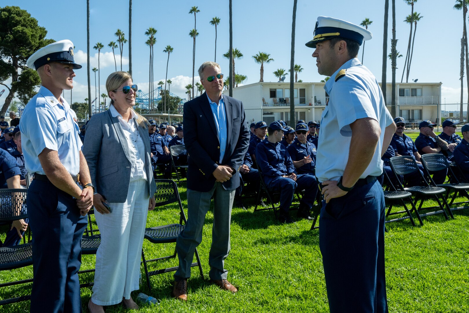 Four people are seen talking to each other at the ceremony.