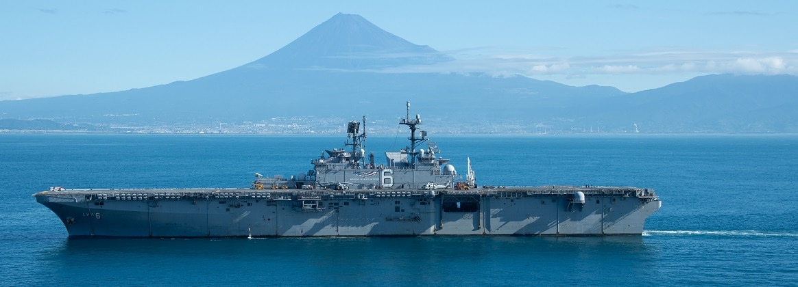 The forward-deployed amphibious assault ship USS America (LHA 6) passes Mount Fuji during Transport Exercise (TRANSPORTEX), Sept. 14.