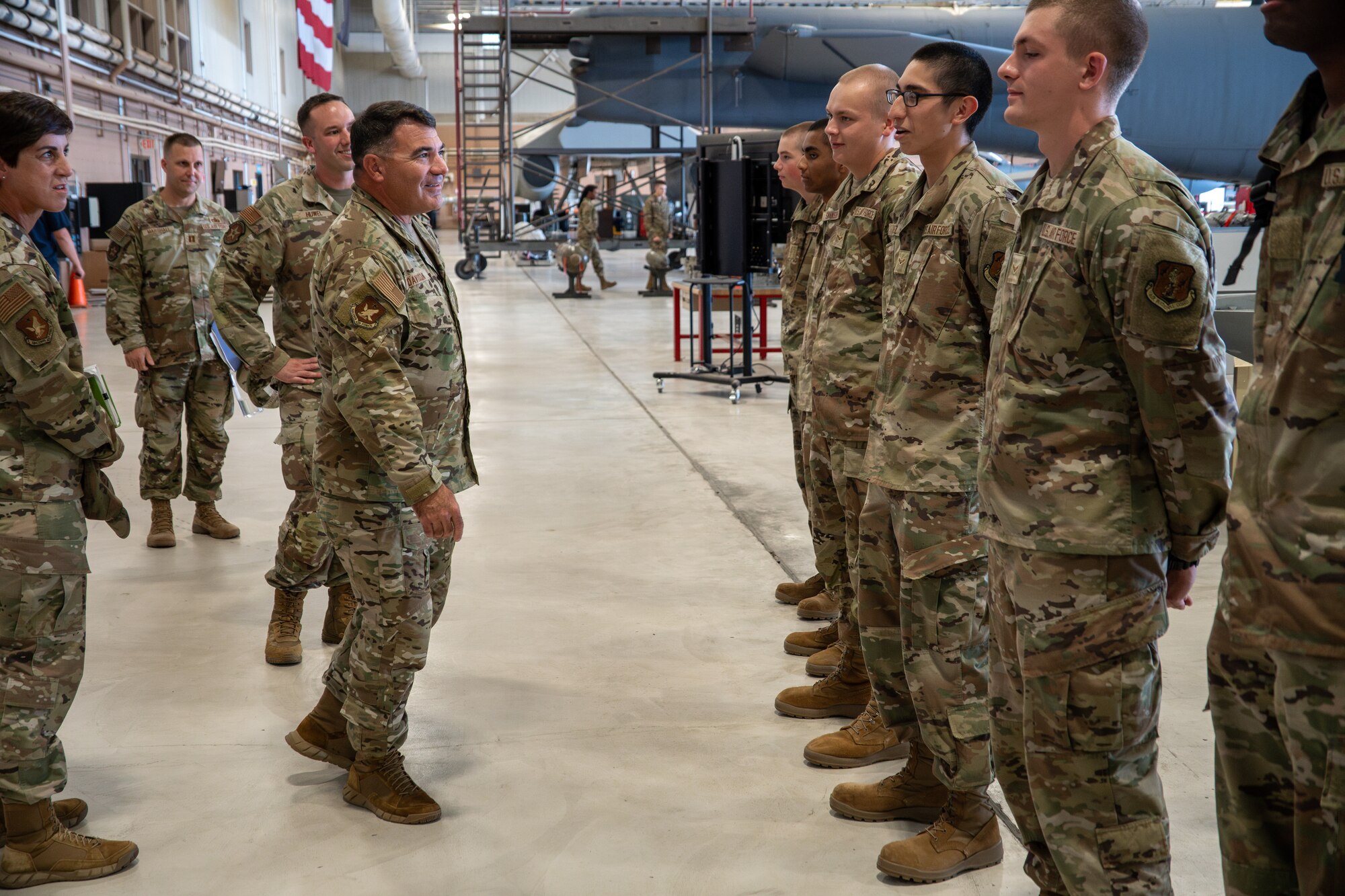 An Airman addresses more Airmen, who are standing at attention.