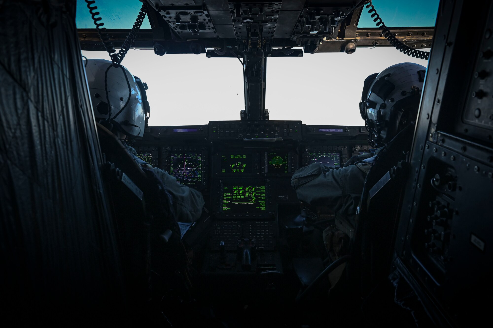 U.S. Marine Corps Capt. Alexander Shaw, left, and U.S. Marine Corps Capt. Elijah Haynes, right, Marine Medium Tiltrotor Squadron (VMM) 262 MV-22B Osprey pilots, fly an MV-22B Osprey aircraft during an airborne jump training.