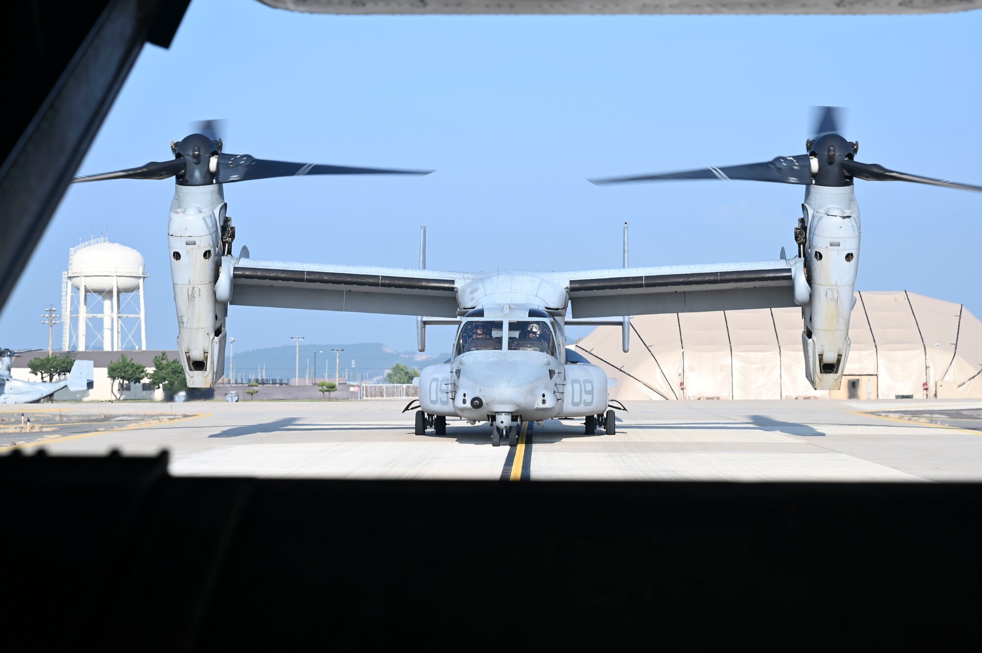 A U.S. Marine Corps MV-22B Osprey aircraft taxis on the runway.