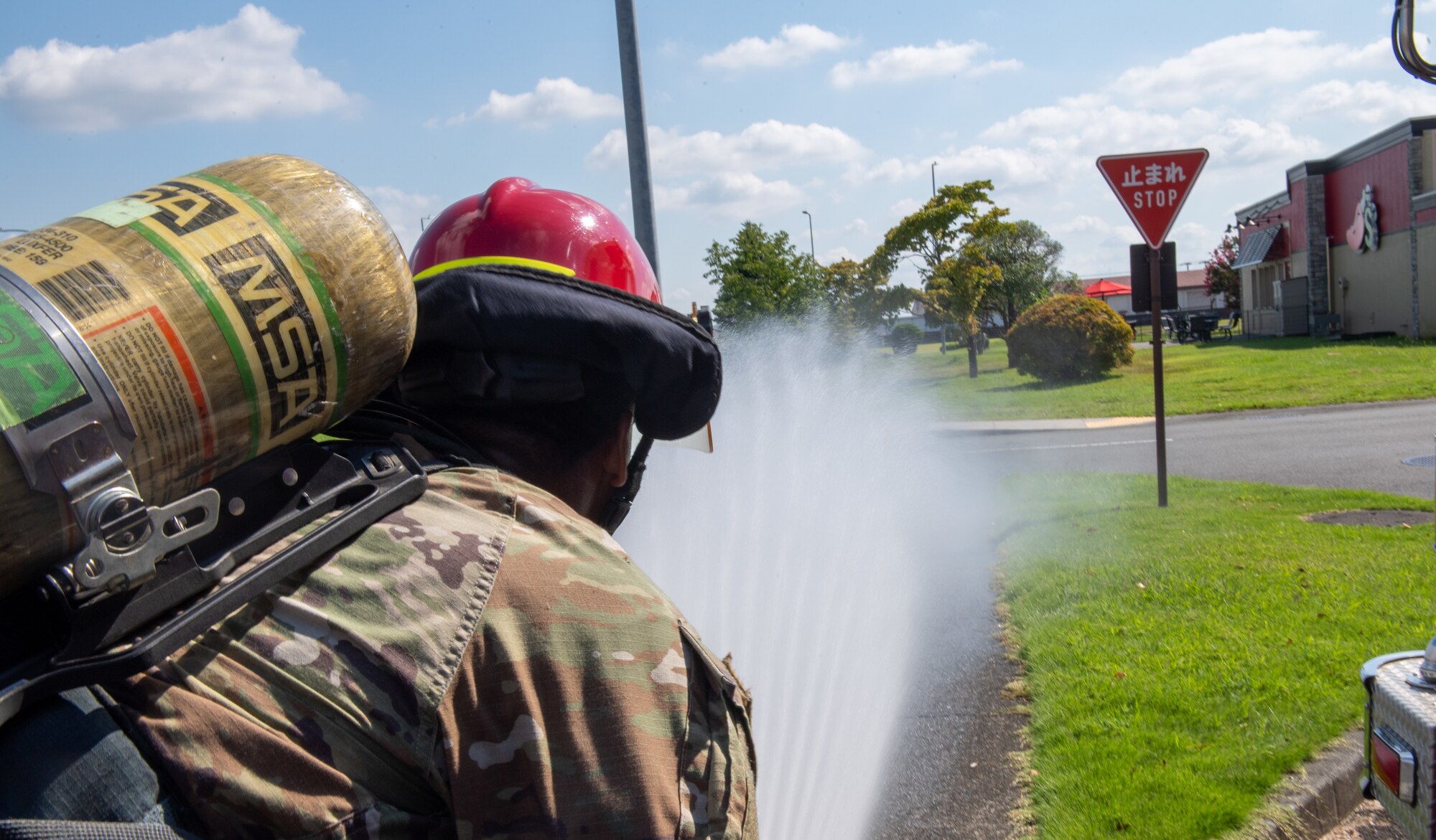 A fire muster challenge participant uses the fire hose as part of the fire muster challenge.