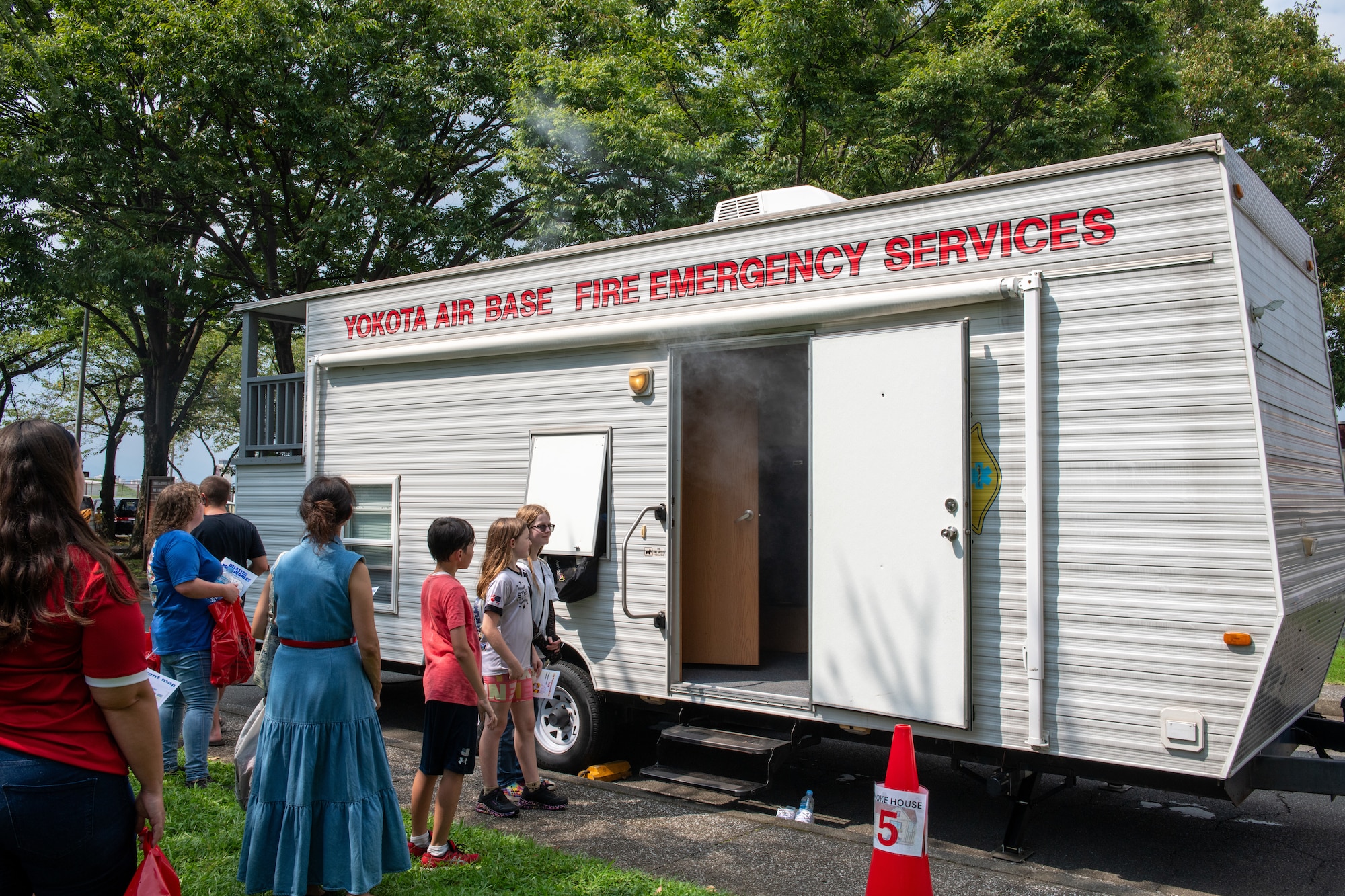 Families wait in queue to enter the smokehouse activity during Fire Prevention Week kickoff event.