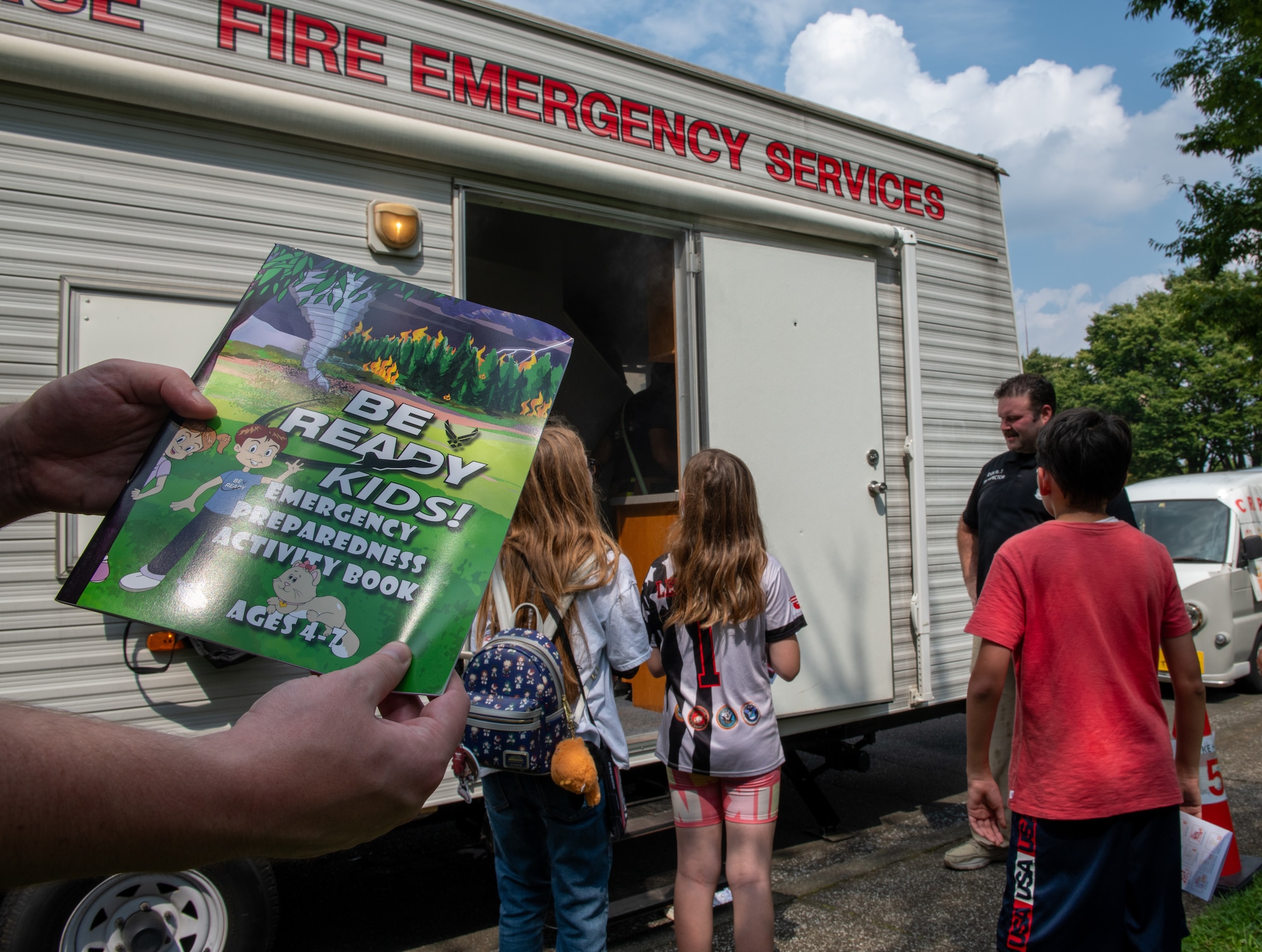 Families wait in queue to enter the smokehouse activity at Fire Prevention Week kickoff event.