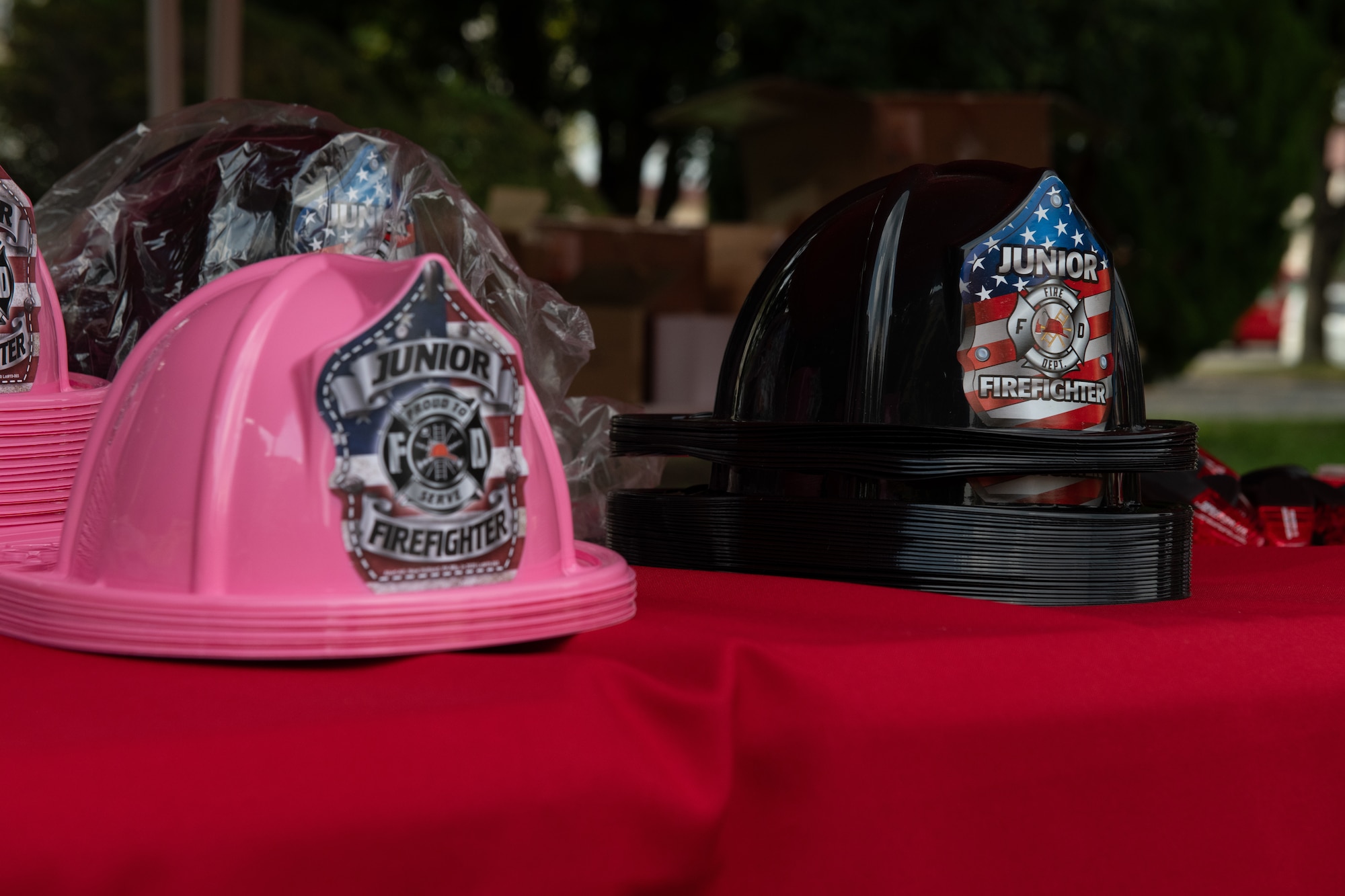 Plastic fire helmets are displayed on a table during the Fire Prevention Week kickoff event.