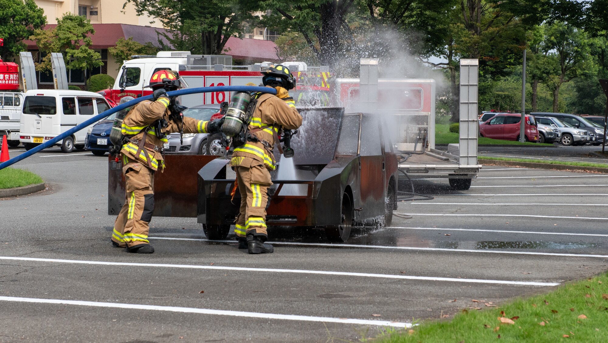 374th Civil Engineer Squadron firefighters extinguish a car fire during a demonstration.