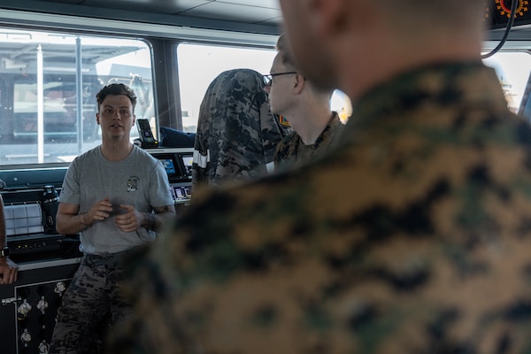 Royal Australian Navy Lt. Benjamin Fennick, left, the executive officer of ADV Cape Pillar, gives a tour of the ADV Cape Pillar to U.S. Sailors with Marine Rotational Force – Darwin 24.3 at Larrakeyah Defence Precinct, NT, Australia, Sep. 2, 2024. Sailors received a tour of ADV Cape Pillar following an OPRES Resilience and BattleSMART brief to bring awareness to mental health in the military and ways to cope or get help for problems that occur. (U.S. Marine Corps photo by Cpl. Manuel Rivera)