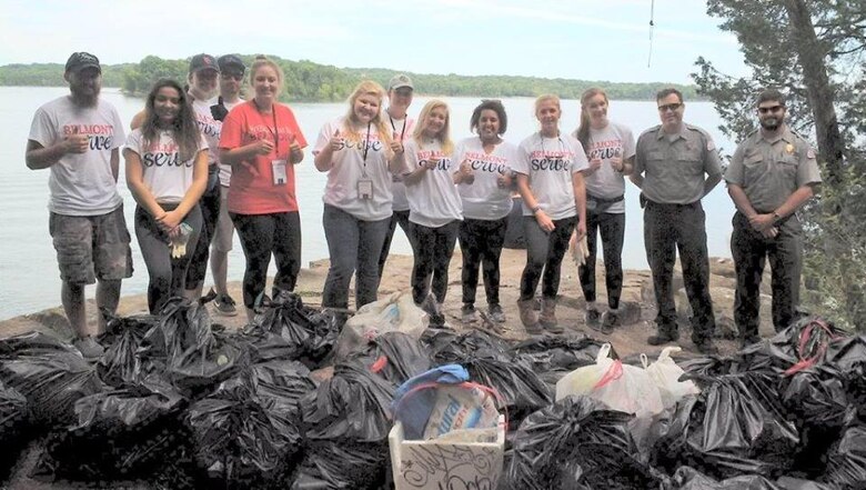 Belmont University students and U.S. Army Corps of Engineers Nashville District park rangers at J. Percy Priest Lake pose with trash collected during a lake cleanup event Aug. 22, 2016. It was a recognized National Public Lands Day event.