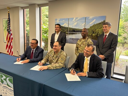 Leaders sign an agreement and pose for a group photo