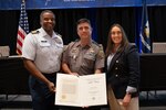 Capt. Ulysses Mullins, Coast Guard Eighth District Chief of Staff, presented Louisiana Department of Wildlife and Fisheries’ Sgt. Stephen Rhodes with the Coast Guard Silver Lifesaving Medal, Tuesday, Sept. 17, in New Orleans. Sgt. Rhodes received the medal in recognition of his heroic actions on May 7, 2022 when he saved the lives of nine people after their vessel capsized in rough water near Grand Isle, Louisiana. (U.S. Coast Guard photo by Petty Officer 3rd Class Jaiden Hartley)