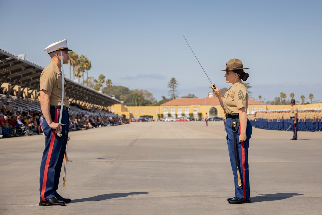 U.S. Marine Corps 1st Sgt. Jessica Padilla, right, company first sergeant, salutes Capt. Michael C. Seibert, company commander, both with Charlie Company, 1st Recruit Training Battalion, during a graduation ceremony at Marine Corps Recruit Depot San Diego, California, Sept. 13, 2024. This ceremony marked the end of a 13-week transformation that included training in drill, marksmanship, basic combat skills, and Marine Corps customs and traditions. (U.S. Marine Corps photo by Lance Cpl. Janell B. Alvarez)