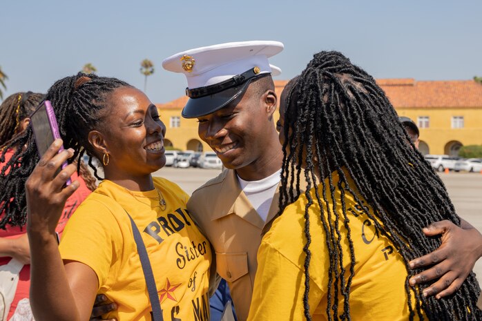 U.S. Marine Corps Pfc. Keston Sylvester, a new Marine with Charlie Company, 1st Recruit Training Battalion, greets his friends and family during a graduation ceremony at Marine Corps Recruit Depot San Diego, California, Sept. 13, 2024. This ceremony marked the end of a 13-week transformation that included training in drill, marksmanship, basic combat skills, and Marine Corps customs and traditions. (U.S. Marine Corps photo by Lance Cpl. Janell B. Alvarez)