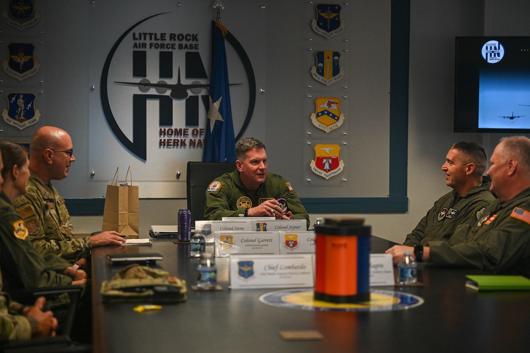 People sit at a conference room table.