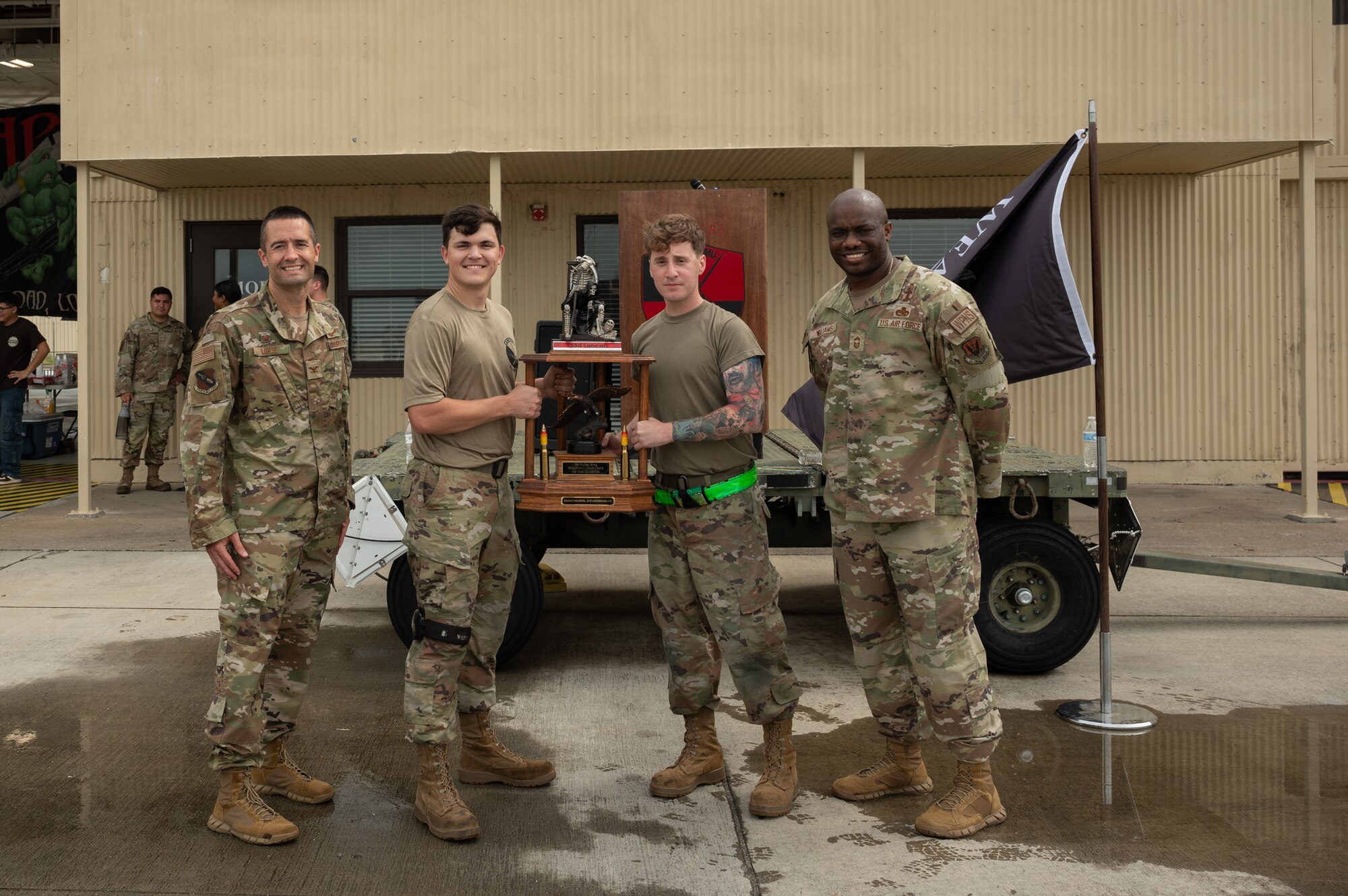 U.S. Air Force Airmen assigned to the 411th Fighter Group pose for a photo after winning 1st place at a 2nd quarter weapons load crew competition at Seymour Johnson Air Force Base, North Carolina, July 31, 2024. The teams consisted of Airmen assigned to the 333rd, 334th, 335th and 336th Fighter Generations Squadrons, as well as the 414th Fighter Group. (U.S. Air Force photo by Senior Airman Rebecca Sirimarco-Lang)