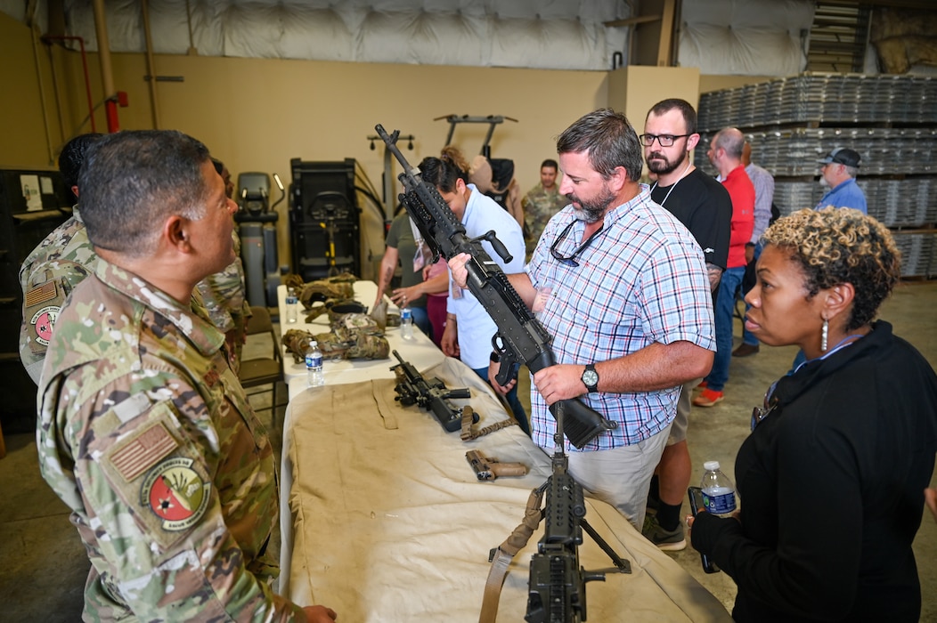 Matthew Werner, Johnson, Mirmiran and Thompson office leader, holds a M240 series machine gun during the “Bosslift” event Sept. 14, 2024, at Joint Base San Antonio-Lackland, Texas.