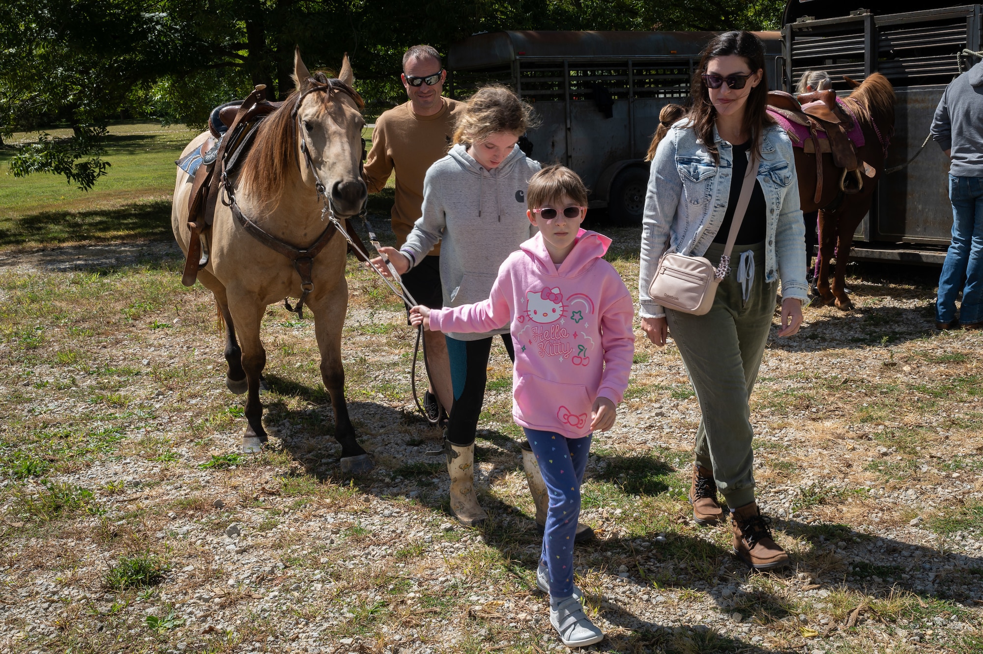 Young riders learn how to work around horses during a horsemanship class