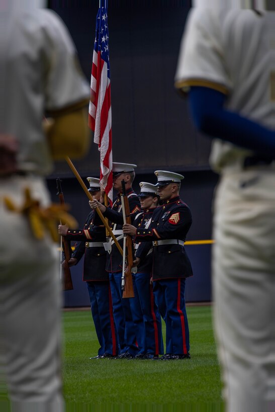 U.S. Marines with Recruiting Station Milwaukee present the national ensign and organizational colors during the opening ceremony of a Milwaukee Brewers game at American Family Field in Milwaukee, Wisc., Sept. 16, 2024. Marines from Recruiting Station Milwaukee were invited by the Brewers to participate during the opening ceremony of a game against the Philadelphia Phillies. (U.S. Marine Corps photo by Cpl. Collette Hagen)