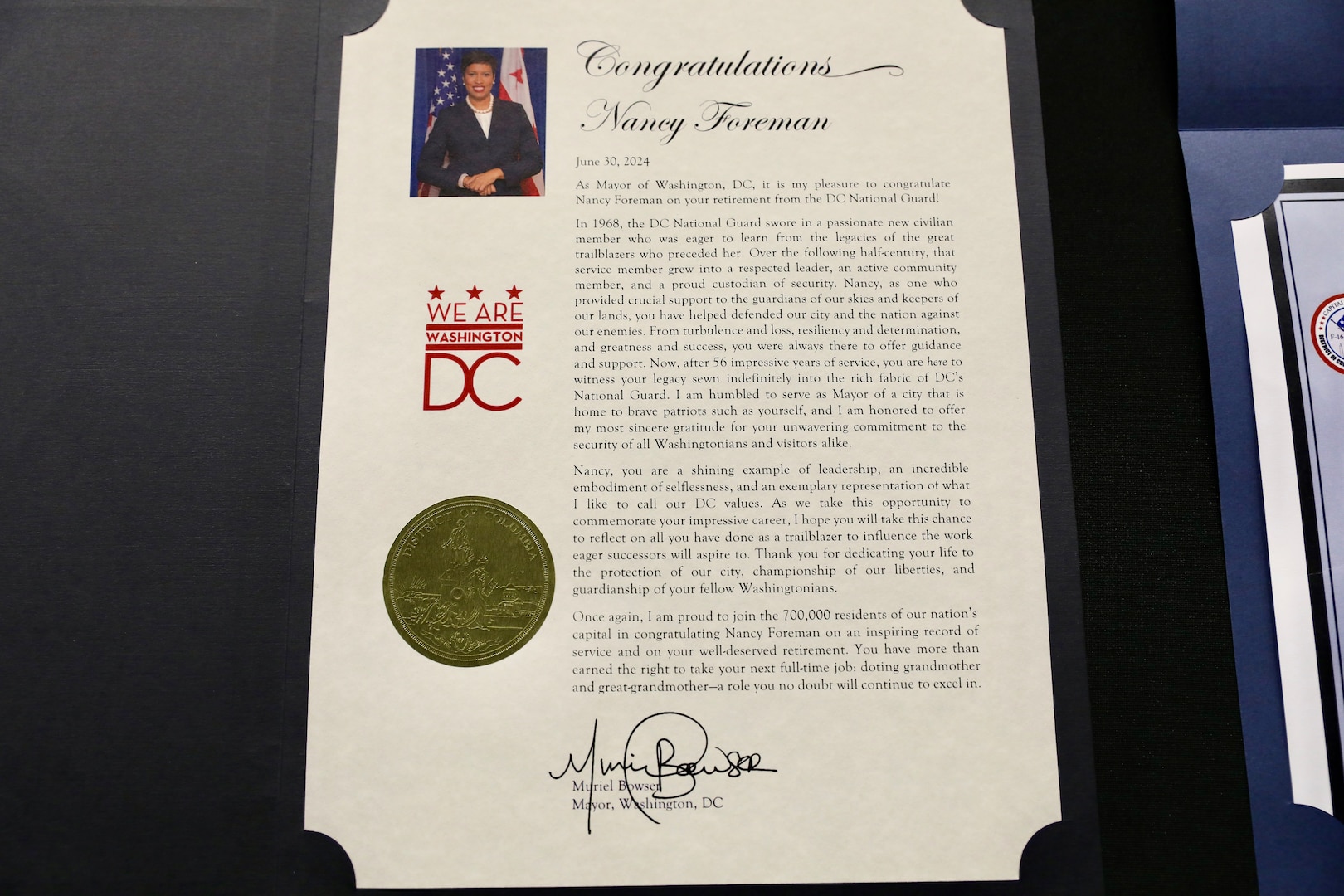 Ms. Nancy Foreman, administrative assistant, D.C. Government Operations-DCNG, retires after 56 years of service at the D.C. Armory, Sept. 13, 2024. The ceremony, officiated by Mr. Marcus Hunt, director, D.C. Govt. Ops-DCNG, included the presentation of the D.C. National Guard Meritorious Service Medal (MSM) by Maj. Gen. John C. Andonie, commanding general (Interim), D.C. National Guard, amongst other awards to include a retirement letter from Mayor Muriel Bowser for Foreman's support to military operational readiness, security and service to Washingtonians.